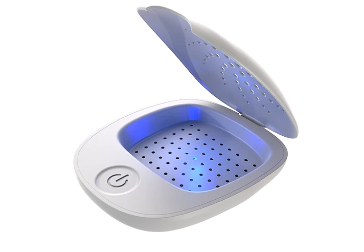 The SereneDry drying box open, showing the UV-lit chamber and single power button